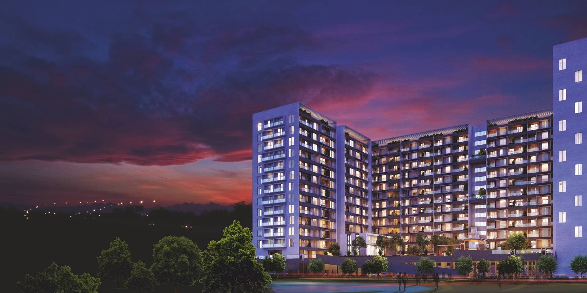 THE PLATINO towers lit up at dusk, Solapur